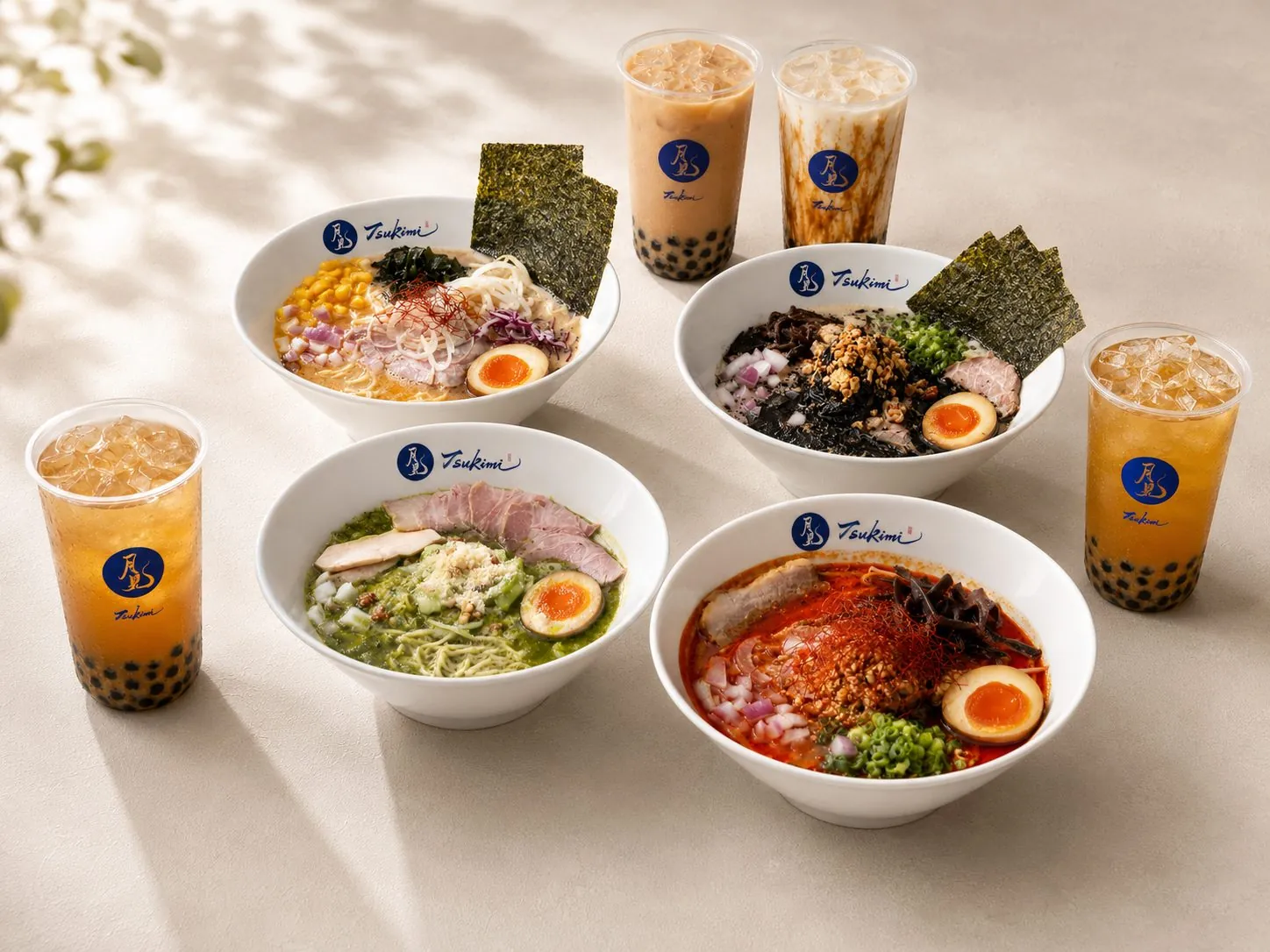 Tsukimi's four ramen bowls and milk teas on a sunlit table